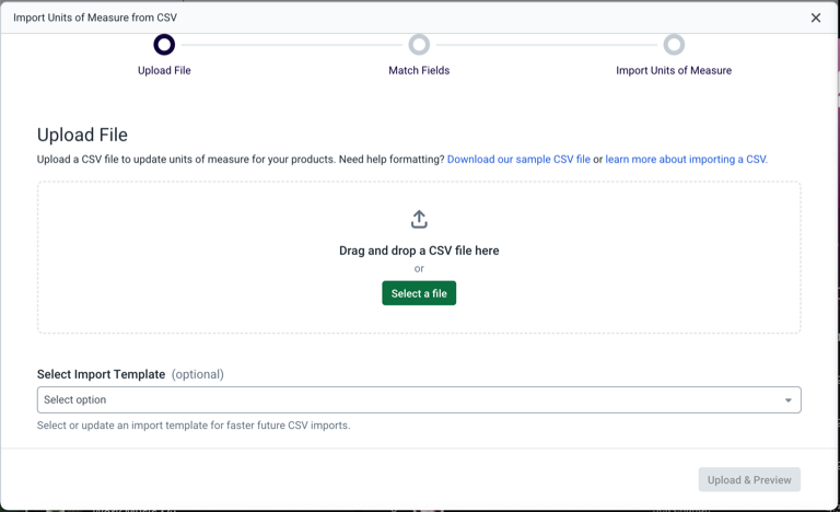 Shows the Upload File step in the Import Units of Measure pop-up window, showing a drag-and-drop area + a link to download a sample CSV file.